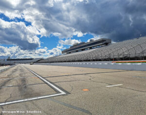 Empty pit lane and grandstands at New Hampshire Motor Speedway in Loudon beneath dramatic clouds before the Classic Bike Experience race weekend.