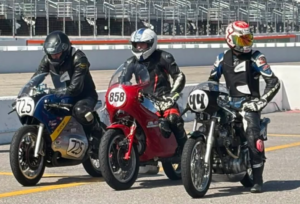 Three Classic Bike Experience racers on vintage motorcycles at Loudon, with Peter on the Suzuki T500, Steve on the Moto Guzzi 850T, and Griff on the Norton Commando.
